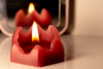 red candle with soft lighting with mirror