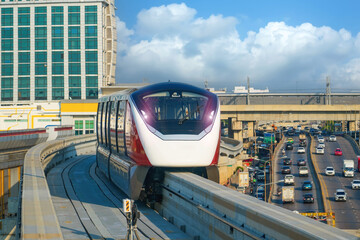 Urban view railway tracks suburban monorail electric train rushing on bridge overpass supports...