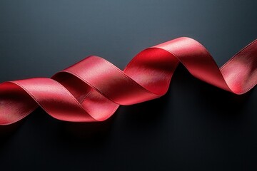 Elegant red satin ribbon on dark background creating a dramatic and stylish decoration concept