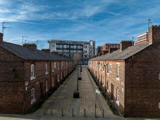 A Victorian street from the Industrial Revolution in the modern city of Manchester. These houses were built to ease the housing crisis borne by the Industrial Revolution which caused many deaths