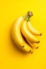 bunch of bananas against a vibrant yellow background, creating an eye-catching and visually appealing composition