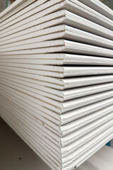 stack of drywall construction sheets	