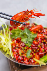 Pick up a spicy Sichuan crayfish with chopsticks