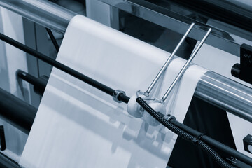 Automatic polyethylene plastic bag production machine with lighting effect. Close-up of the roller...