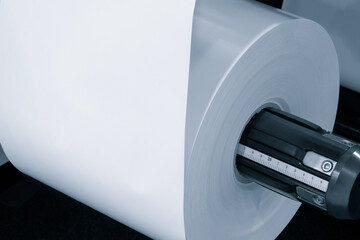 Automatic polyethylene plastic bag production machine with lighting effect. Close-up of the roller...