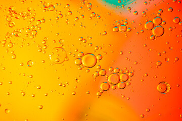 Oil bubbles floating on a bright colored background. Macro shot.