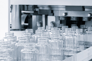 PVC plastic bottle production machine by extrusion and hot blowing technology, industrial concept background