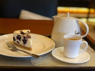 Delicious Blueberry Cheesecake Dessert Served with a Cup of Tea