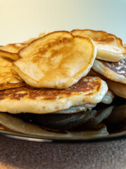 A stack of fried pancakes on a black plate