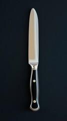 Knife resting on a smooth, dark surface