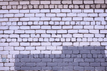 A simple brick wall with a wooden bench in front, perfect for park or cityscape scene.