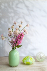 Vase with beautiful wild pink summer flowers 