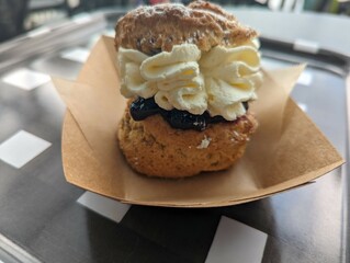 A scone with jam and cream
