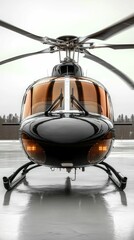 Sleek black helicopter poised on tarmac