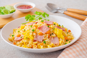 Fried rice with ham pork on white plate.
