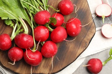 Many fresh radishes on grey table, flat lay