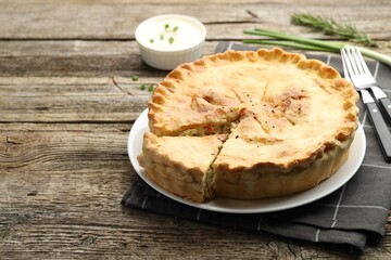 Delicious fresh homemade pie served on wooden table, closeup. Space for text