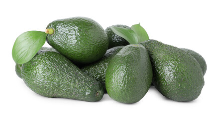 Pile of whole ripe avocados with green leaves isolated on white