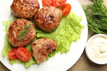 Delicious patties served on wooden table, flat lay