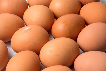 Fresh eggs placed on a white background, isolated and well lit. Ideal image to represent concepts of food, nutrition, home cooking, natural ingredients and healthy diet.