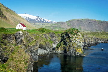 Little white house in Arnarstapi, Snaefellsnes peninsula scenic landscape in Iceland