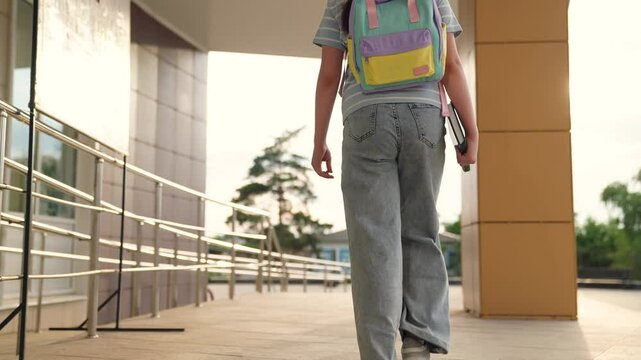 child goes to class holding book hand, educational program, child kid first grader holding book hands runs class, child goes school, child school backpack goes educational classes, child kid carries