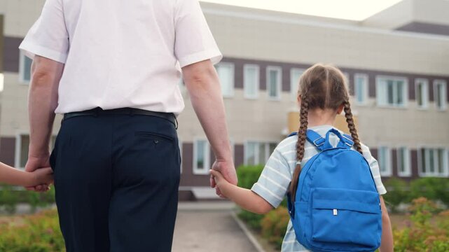child hold father hand go to school, child with school backpacks parent go to class, adult holds child hand, happy family, education kid girls daughters, father parent man sees daughters class
