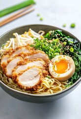 Appetizing bowl of ramen with crispy chicken, egg, greens, and sprouts. A culinary delight
