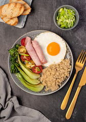 Food photography of balanced breakfast, fried egg with quinoa, bok choy, ham, tomatoes, spring onion, toasts, dietary fiber, healthy food