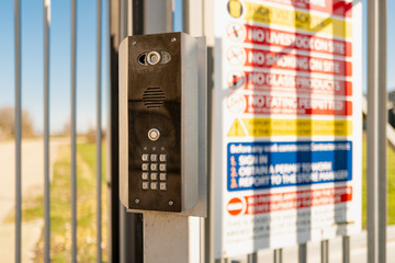 Electronic access keypad and security camera seen at the entrance to a British industrial complex...