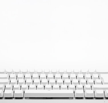 Blank white keyboard. Wireless gaming mechanical computer keyboard closeup, isolated. Minimal, modern design on white background. front view. 60 percent keyboard. copy space. Communication device.
