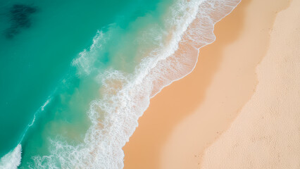 Aerial View of Tropical Beach with Soft Waves and Sandy Shoreline Under Clear Blue Sky