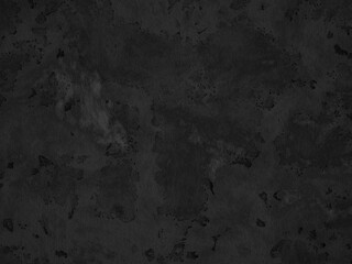 A textured dark concrete surface with noticeable spots and uneven finish.