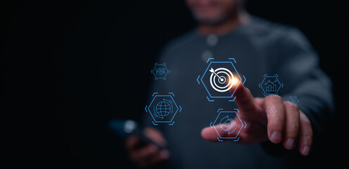 A man is pointing at a screen with a blue arrow and a target