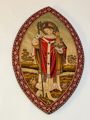 Fabric artwork depicting St. Willibrord dressed as a bishop with a staff and the church in his hand. Basilica of Echternach.