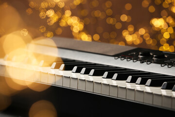 Piano against blurred lights, closeup. Bokeh effect