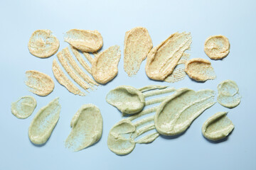 Samples of body scrubs on light background, flat lay