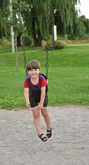 child walking near swing in park,