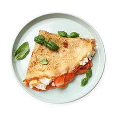 Delicious crepe with salmon, cream cheese and basil isolated on white, top view
