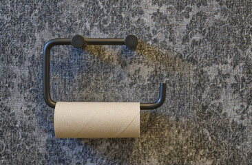 Minimalist Black Toilet Paper Holder on Gray Wall