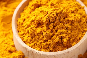 Turmeric powder in bowl on spice, closeup
