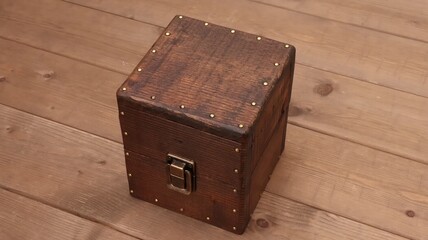 old wooden box with lock on wooden background