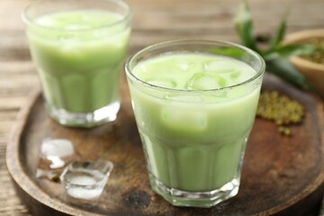 Fresh mung bean juice with ice on wooden table, closeup