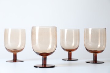 Many empty clean glasses on light background