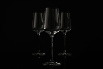 Three empty clean glasses on black background
