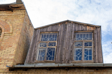 Old wooden attic above the roof of the house. Attic with windows home architecture