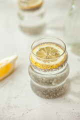 Chia water with lemon on white background - healthy drink to start the day, great for hydration, digestion and detox, shot in bright morning light
