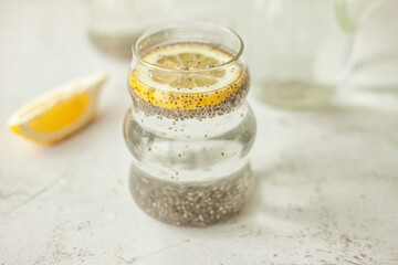 Chia water with lemon on white background - healthy drink to start the day, great for hydration, digestion and detox, shot in bright morning light