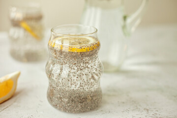 Chia water with lemon on white background - healthy drink to start the day, great for hydration, digestion and detox, shot in bright morning light