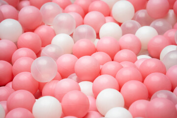 pink plastic balls in a ball pool at a children's indoor playground